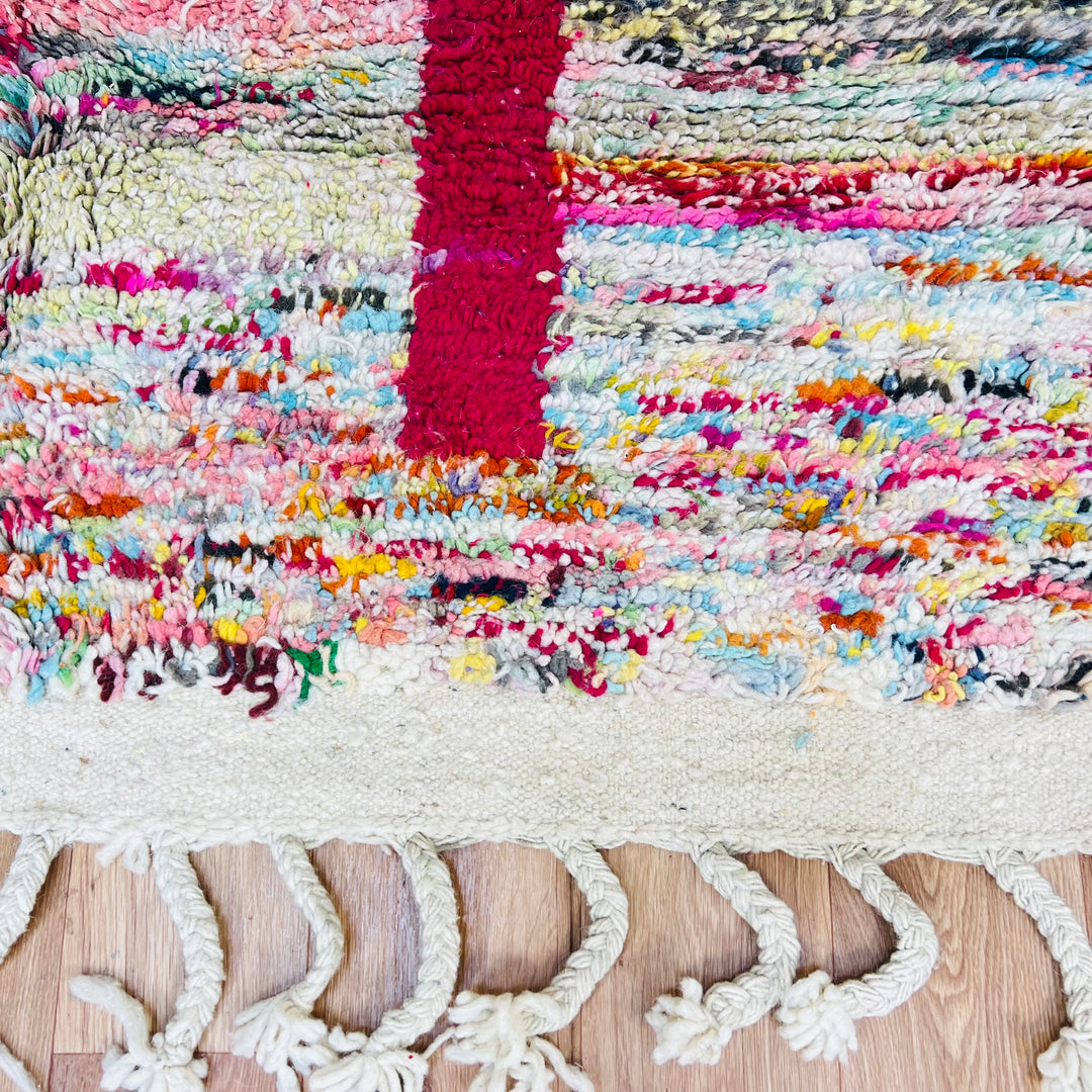 Colorful Moroccan Berber Wool Rug with abstract patterns and fringes, showcasing vibrant pink, blue, black, and green hues, 8x5ft.
