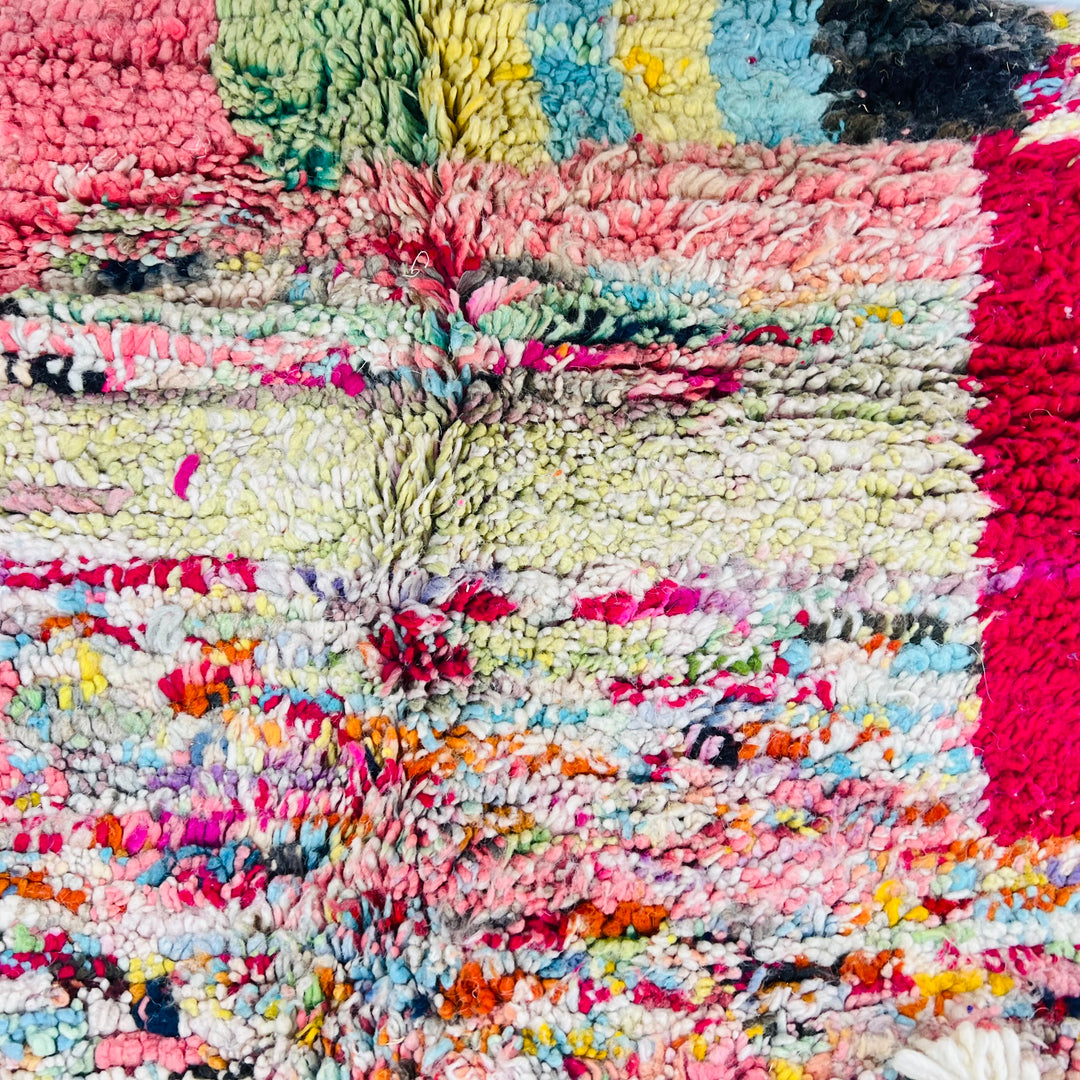 Colorful Moroccan Berber wool rug with vibrant pink, blue, and green abstract design, handcrafted by artisans. 8x5ft.