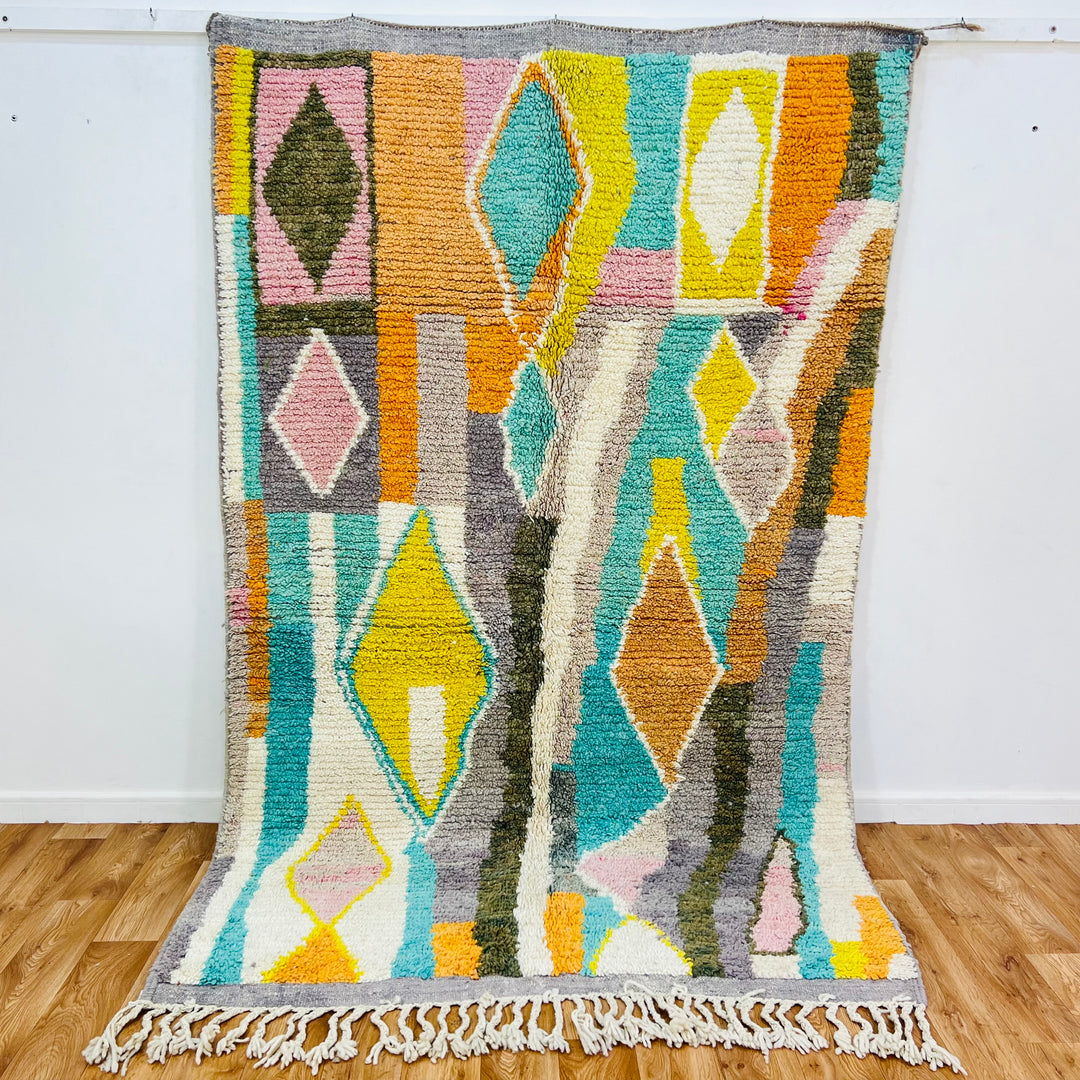 Colorful Moroccan wool rug with diamond patterns in orange, teal, yellow, and pink; 264x160 cm; handmade Berber style.