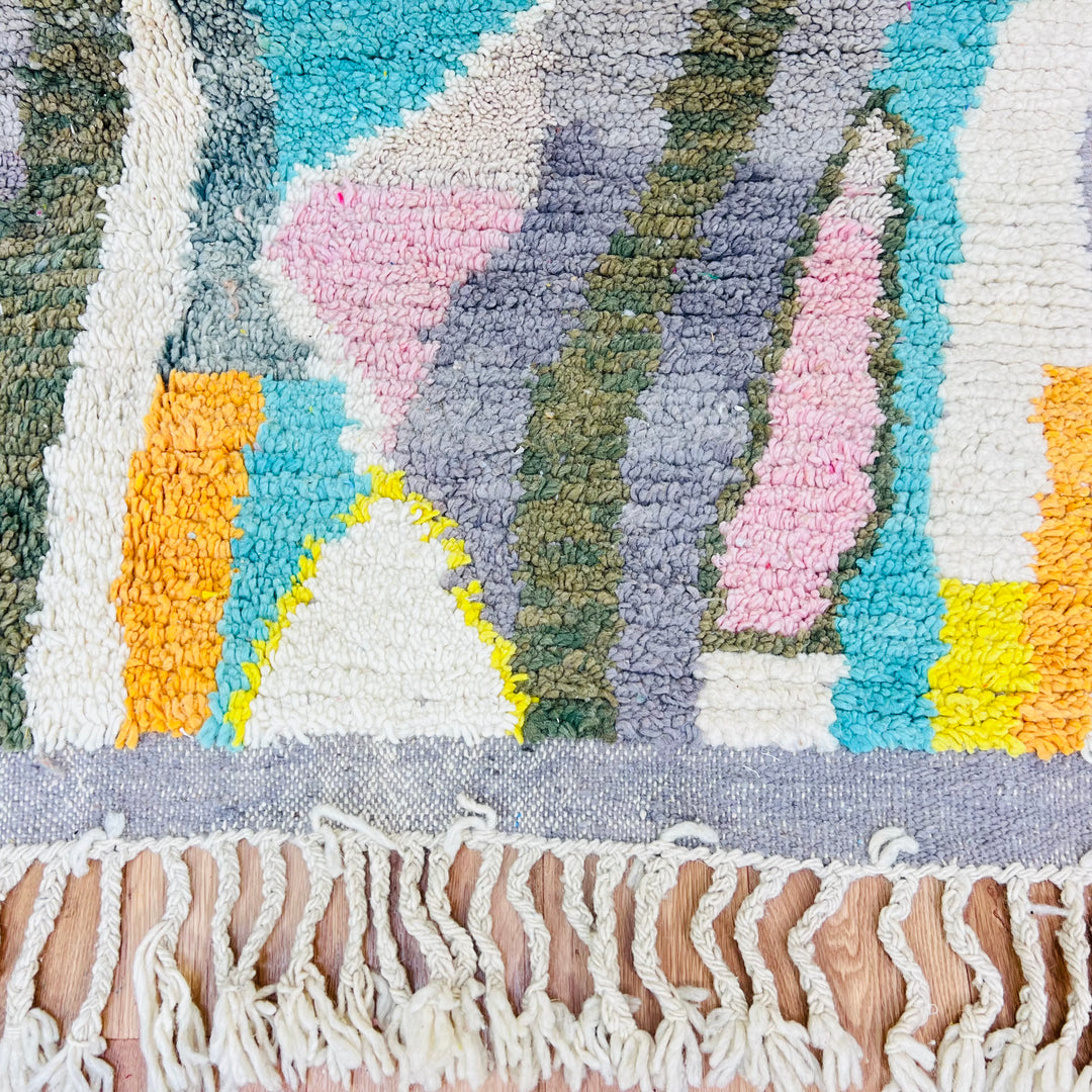 Colorful Moroccan wool rug with diamond patterns in orange, teal, yellow, and pink; traditional Berber design; 264x160 cm.