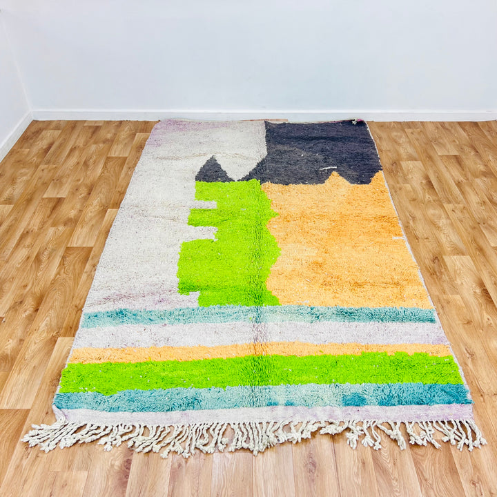 Color block Moroccan rug with geometric patterns in black, orange, lime green, and ivory tones. Handwoven wool rug 260 x 163 cm.