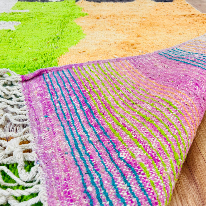 Handwoven Color Block Moroccan Rug in vibrant black, orange, lime green, and ivory by Berber women, showcasing Moroccan artistry.