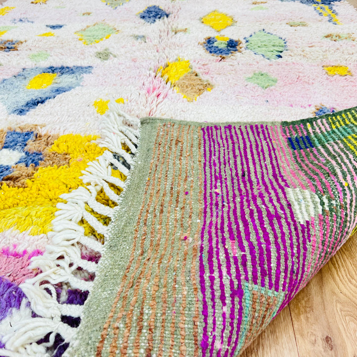 Pink and yellow vintage Moroccan rug with Berber symbols and tribal motifs, 7x5 ft, thick wool texture, ideal for living spaces.