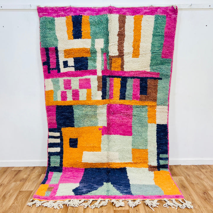 Colorful abstract vintage Moroccan rug with pink, blue, and orange geometric patterns, 251x154cm, by Berber artisans.