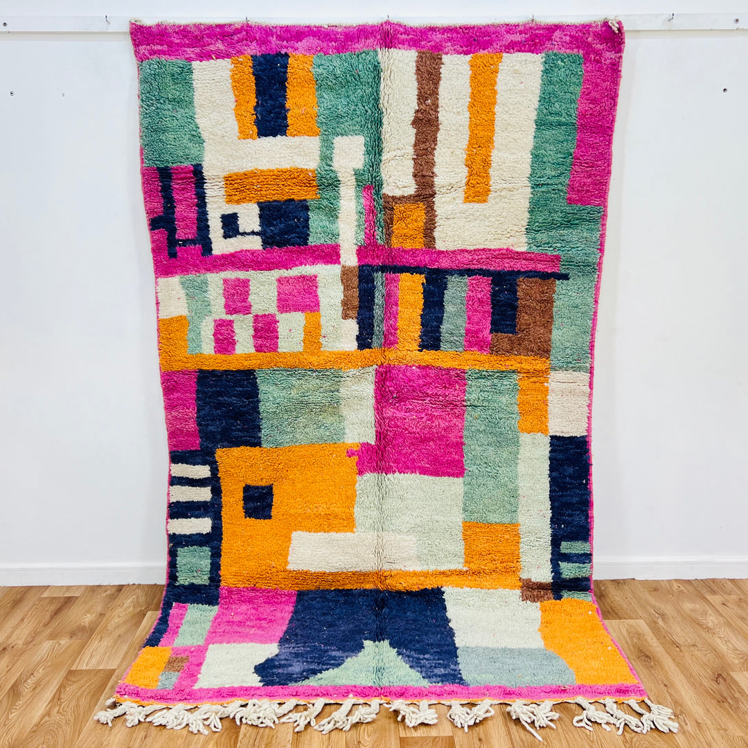 Colorful abstract vintage Moroccan rug with pink, blue, and orange geometric patterns, 251x154cm, by Berber artisans.