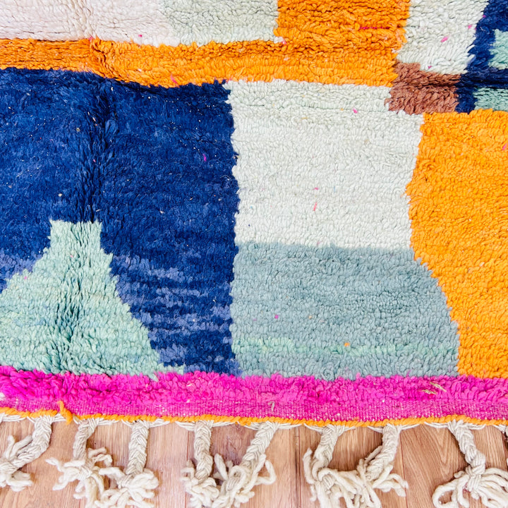 Colorful abstract vintage Moroccan rug with fuchsia, orange, and blue geometric patterns, handwoven by Berber artisans, 251x154cm.