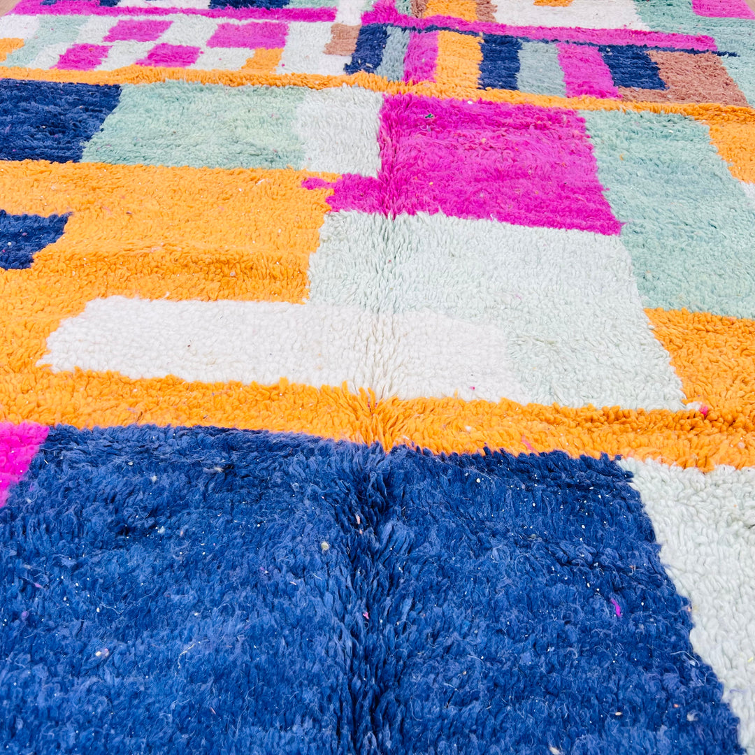 Colorful vintage Moroccan shag rug with abstract geometric patterns in pink, blue, orange, mint, and ivory.