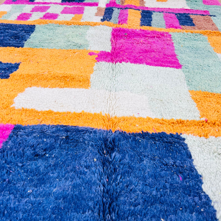 Colorful vintage Moroccan shag rug with abstract geometric patterns in pink, blue, orange, mint, and ivory.