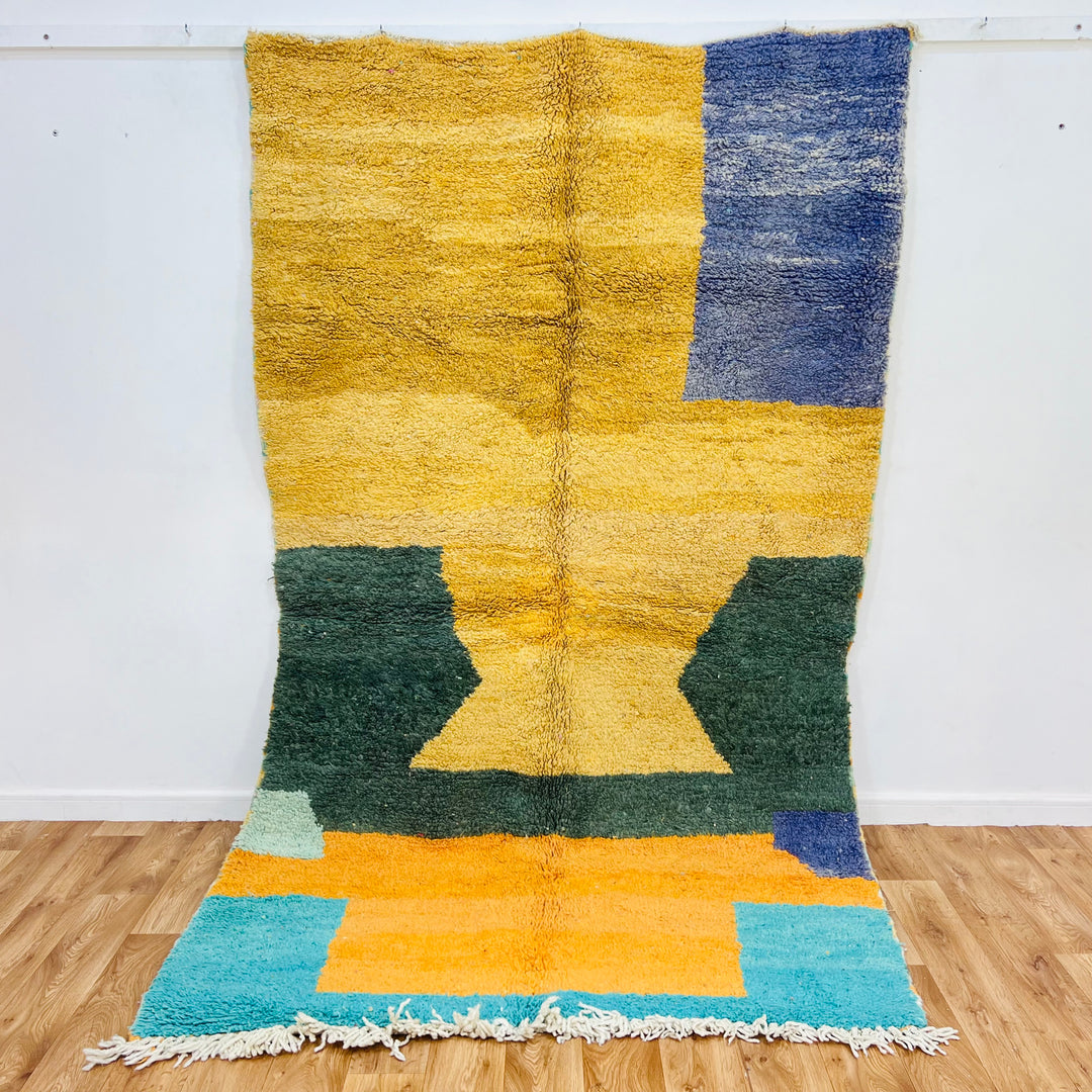 Yellow and green abstract Moroccan Berber rug, 8.8x5 ft, featuring geometric patterns with desert sunset colors in handmade wool.