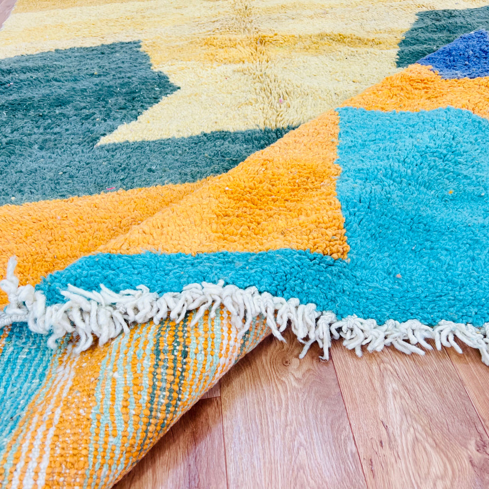 Yellow and green abstract Moroccan rug with geometric pattern in orange, aqua, and blue; handmade 100% wool Moroccan Berber carpet.
