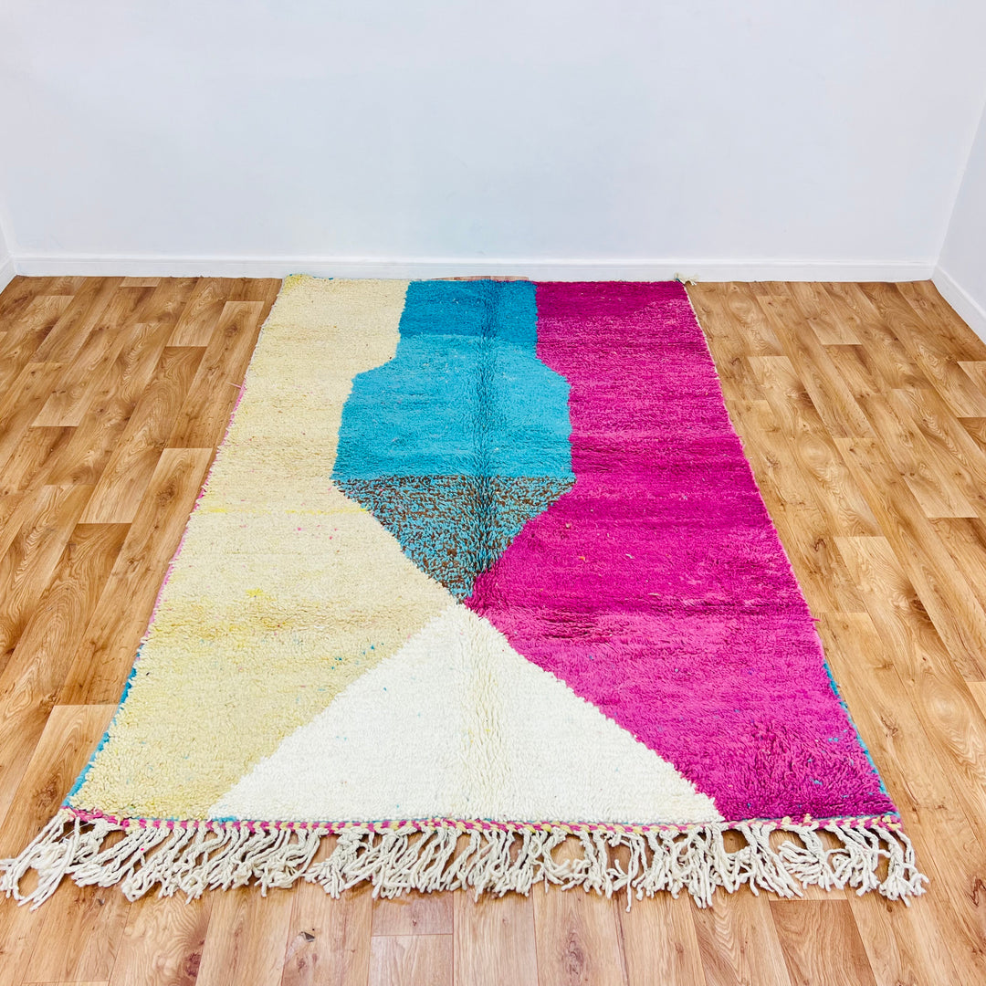 Colorful Moroccan wool rug with pink, aqua, and cream abstract pattern, 250x156 cm. Ideal boho Moroccan shag area rug.