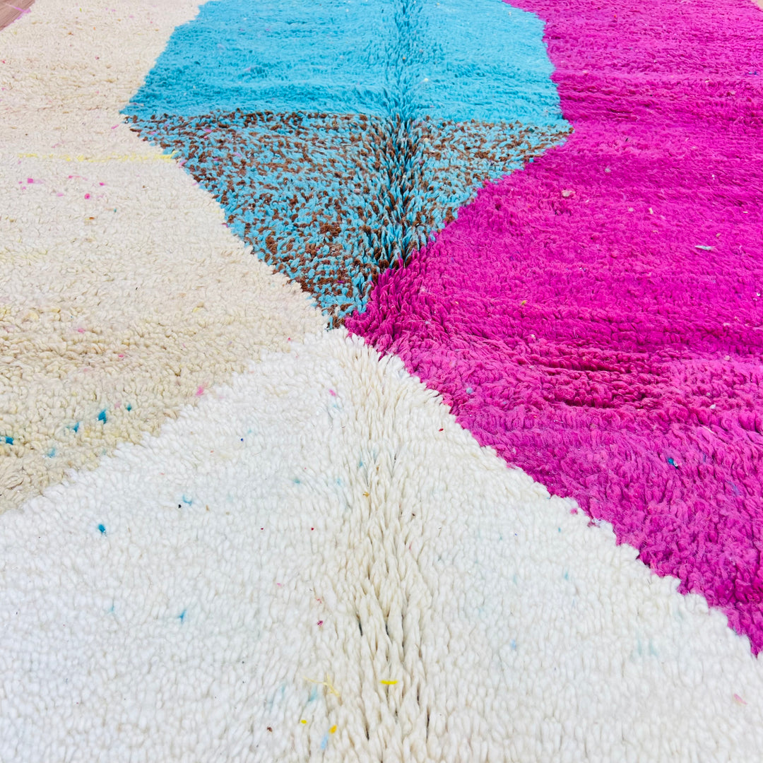 Pink and aqua Moroccan wool rug with geometric design, featuring deep pink, turquoise, cream, and mustard accents. 250 x 156 cm.