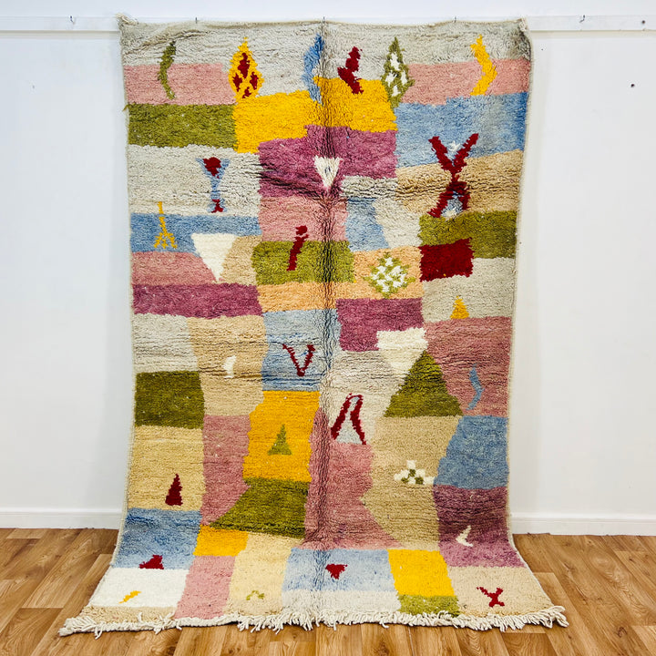 Vintage Moroccan wool rug in soft pinks, yellows, blues, and olive green, handwoven with Berber symbols, 248x153 cm.