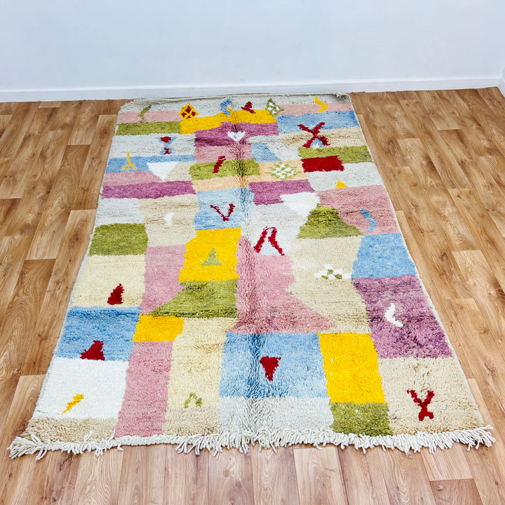 Colorful vintage Moroccan wool rug with patchwork design in pink, blue, yellow, olive, and burgundy, 248x153 cm, handwoven Berber style.