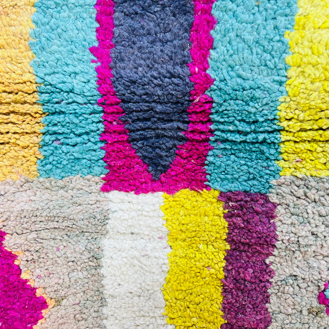 Colorful Beni Mrirt Moroccan rug with vibrant pink, yellow, teal, and black diamond patterns. Handmade wool rug from Morocco.