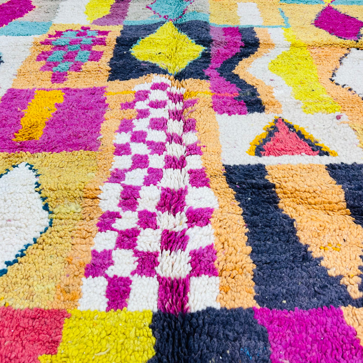 Colorful Beni Mrirt Moroccan rug with pink, yellow, black, and teal diamond and checkerboard motifs, 251 x 164 cm.