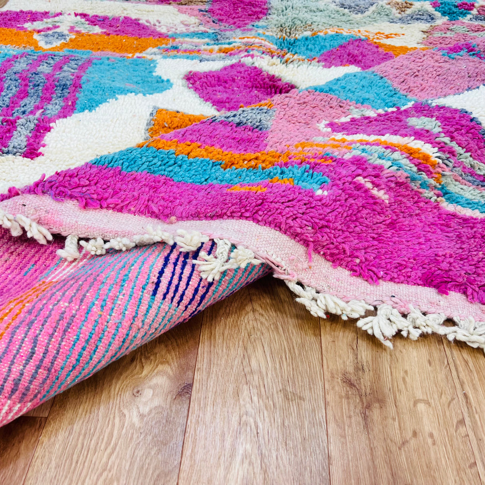 Colorful Moroccan Berber Wool Rug with vibrant geometric patterns, handmade from natural wool. Perfect for eclectic interiors.