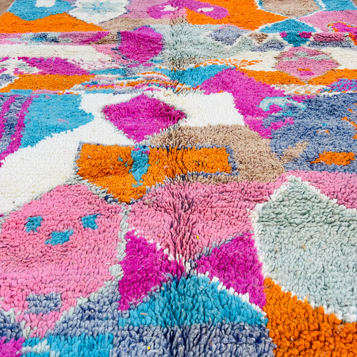 Colorful Moroccan wool rug with geometric patterns in pink, orange, turquoise, and cream, 266 x 153 cm, handmade by Berber artisans.