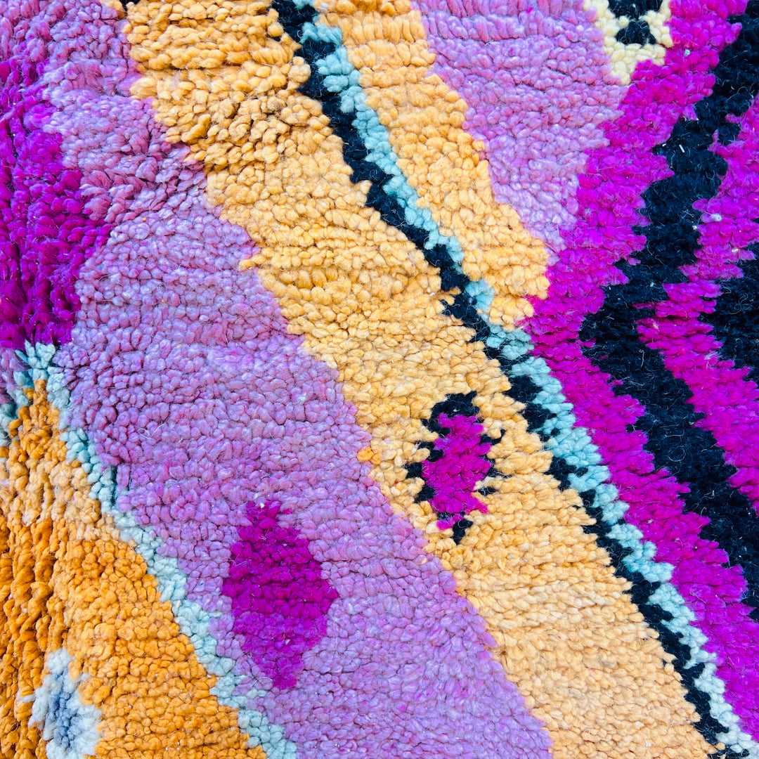 Pink Diamond Moroccan Wool Rug featuring vibrant shades of pink, mustard, and black with traditional patterns.