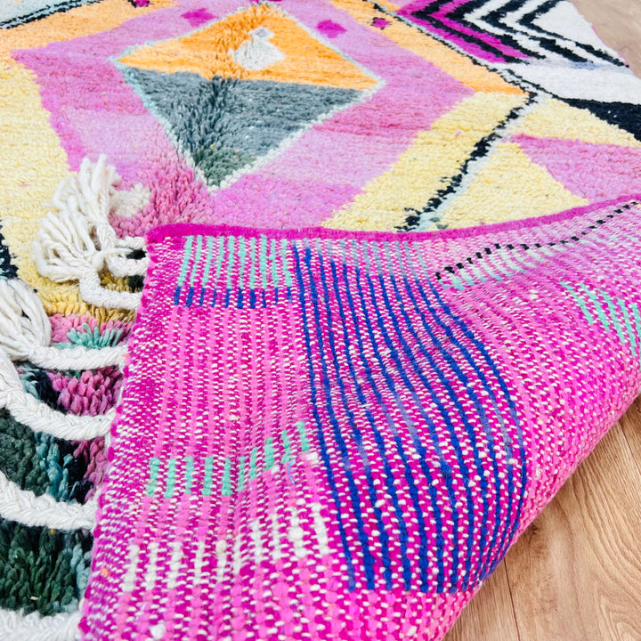 Pink Diamond Moroccan Wool Rug with vibrant colors and traditional Berber design, handmade from natural wool by Moroccan artisans.