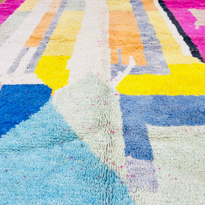 Modern Abstract Moroccan Wool Rug with geometric patterns in pink, yellow, blue, and cream hues, handmade by Berber artisans.