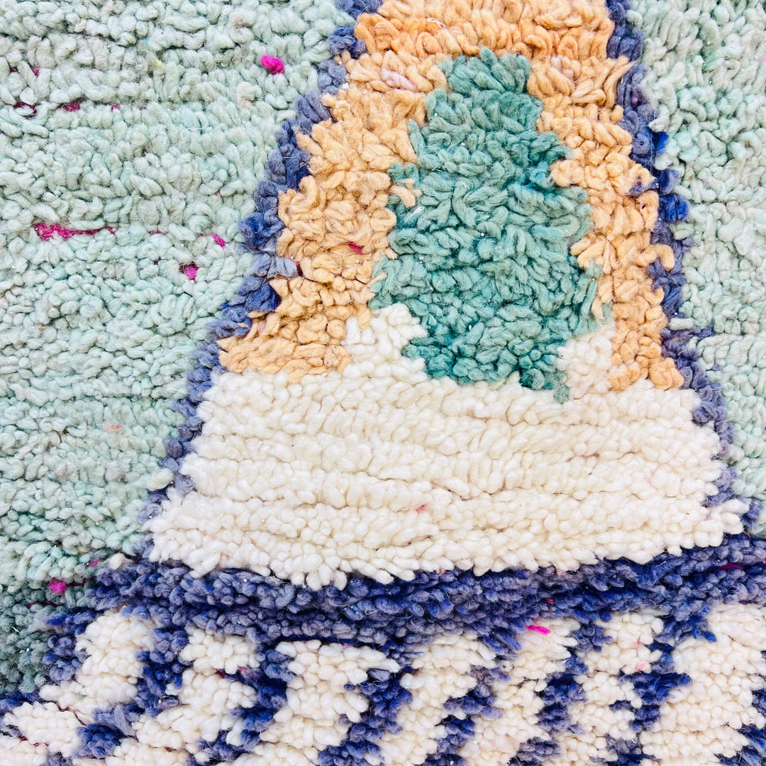 Geometric Moroccan wool rug with peach, mint, and navy pyramid shapes, handwoven by Berber women. Moroccan rug 8x10.
