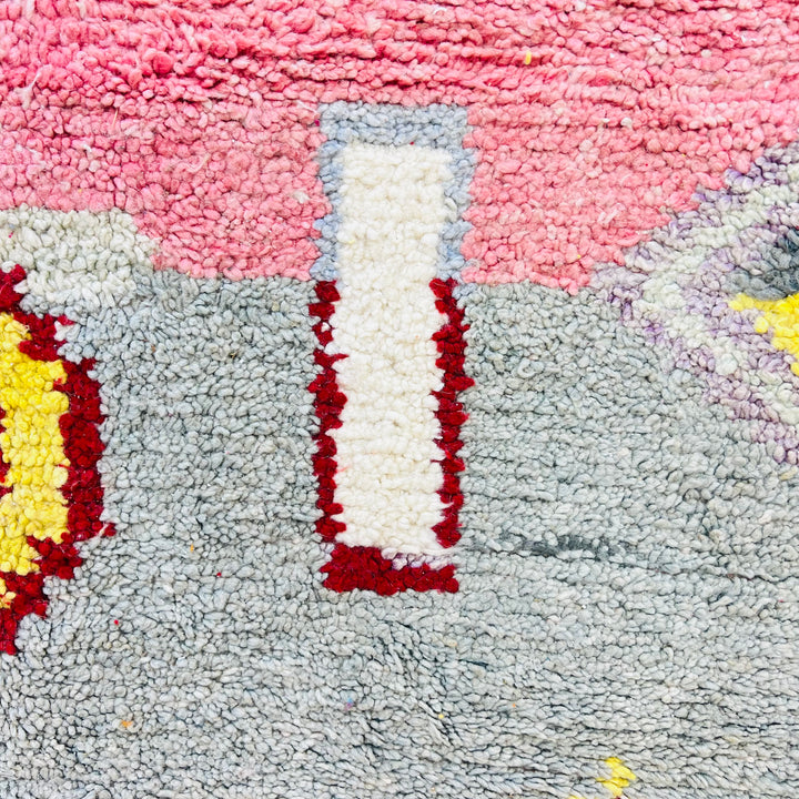 Abstract Berber Moroccan wool rug with geometric shapes in pink, grey, and red by women artisans from the Atlas Mountains.