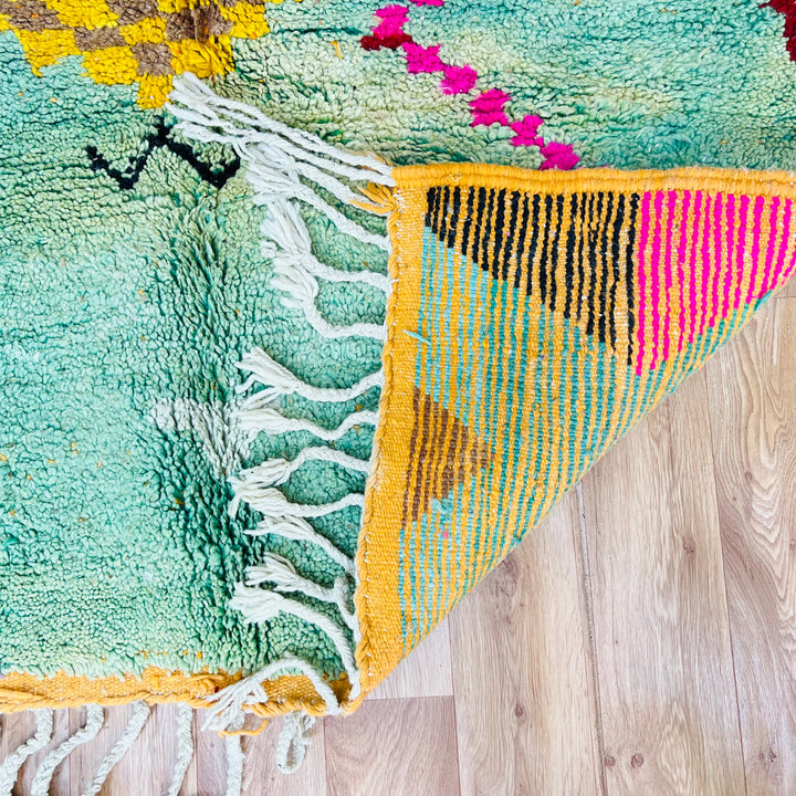 Playful Moroccan Berber Wool Rug with vibrant colors and tribal symbols, showcasing checkered patterns and motifs, ideal for home decor.
