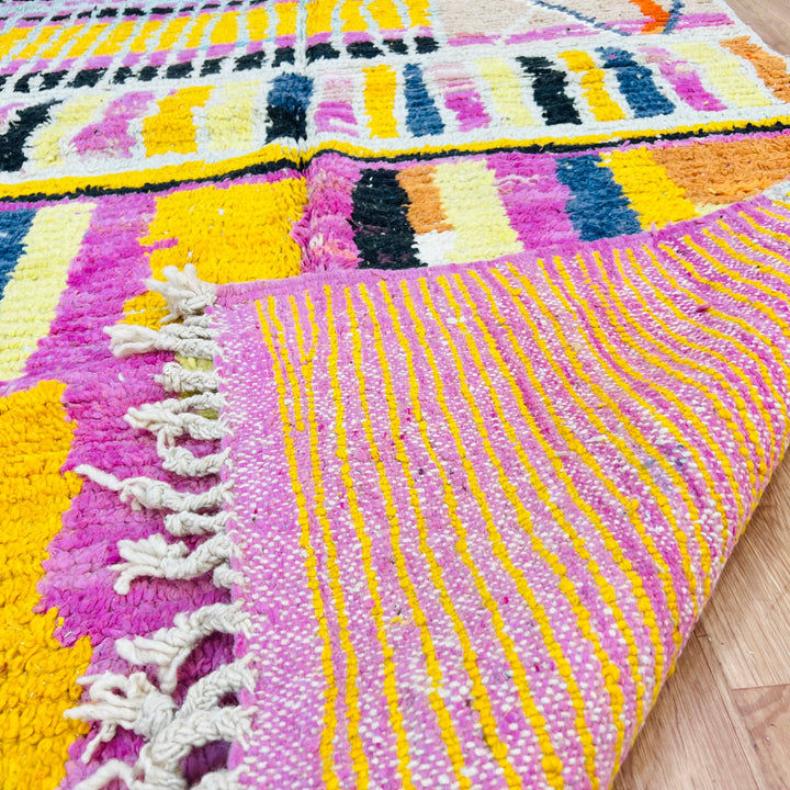 Striped Yellow Moroccan Wool Rug with pink, black, and orange patterns, handmade by Berber artisans, 245x145 cm. Vibrant design