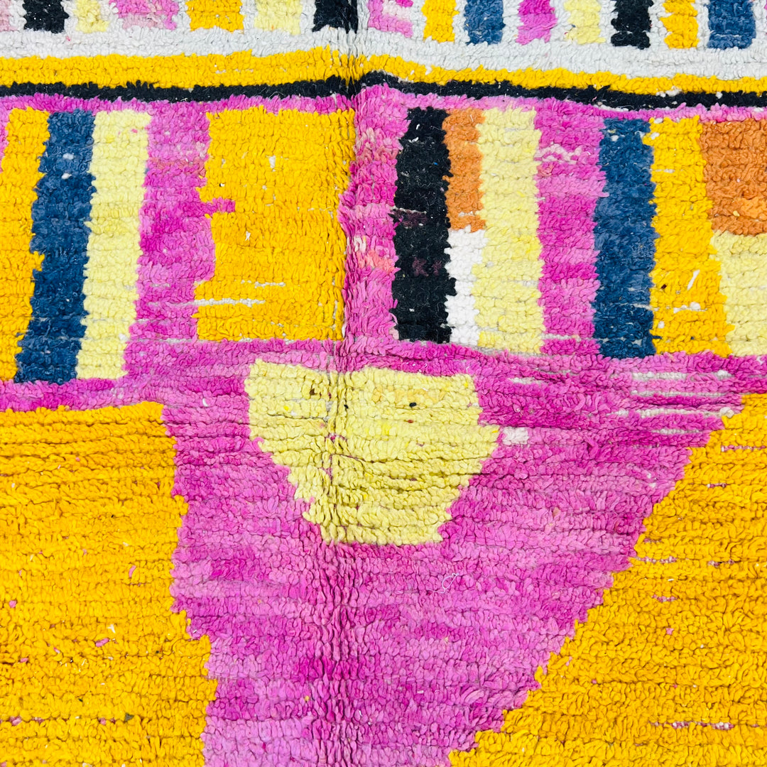 Striped Yellow Moroccan Wool Rug with pink and black accents, handmade by Berber artisans, 245x145 cm, vibrant colors.