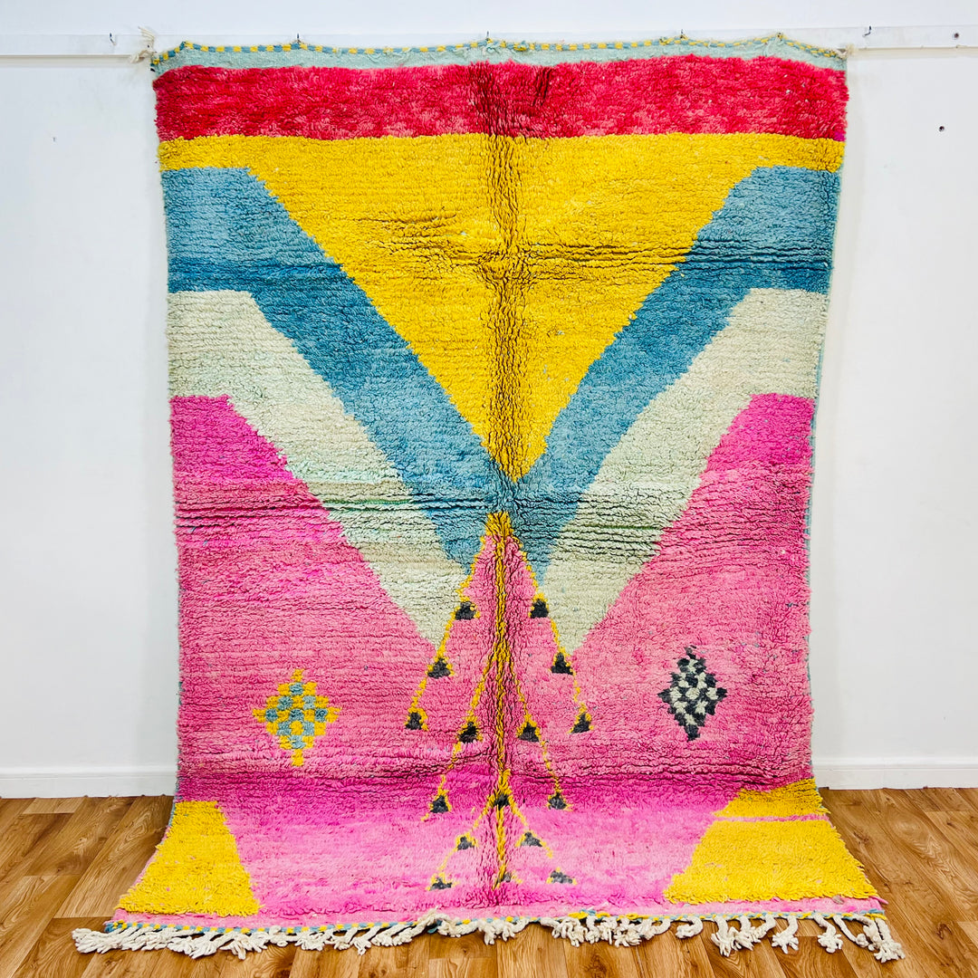 Vintage Moroccan rug with bright pink, yellow, blue, and cream triangles, handwoven Berber design, 8x5.6 ft area rug.