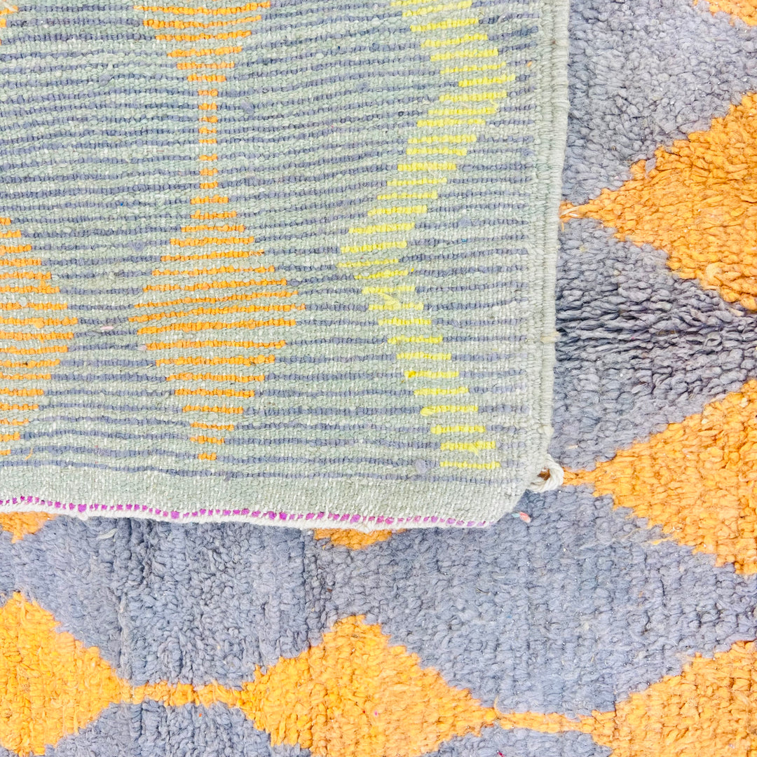 Vintage Moroccan rug with orange and yellow diamond pattern on a grey base, 255x158 cm, handwoven Berber tradition, wool.