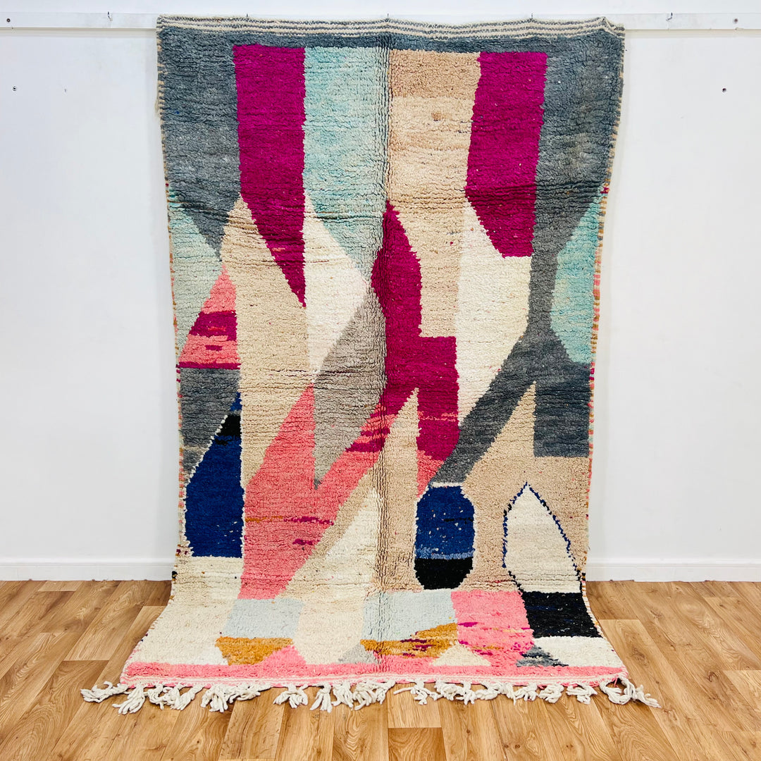 Vintage abstract Moroccan rug in pink, beige, navy, grey, and mustard hues; handwoven wool, 8.3 x 4.9 ft, geometric Berber design.