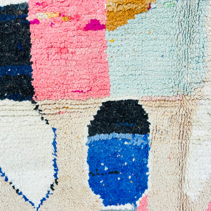 Vintage abstract Moroccan rug with vibrant pink, blue, and beige geometric patterns, handwoven wool, 254 x 150 cm.