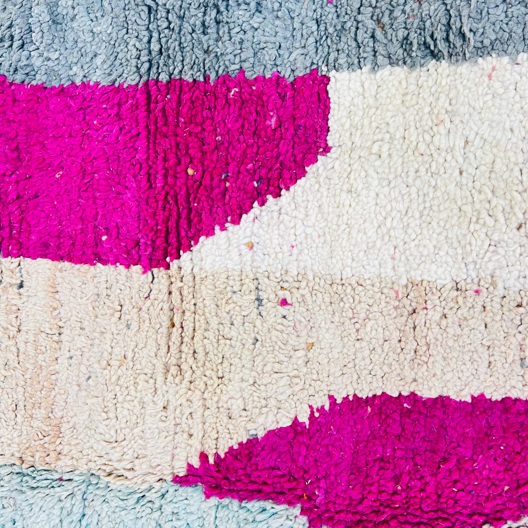 Vintage Moroccan rug with abstract shapes in pink, beige, and gray, showcasing traditional Berber design. Size: 254 x 150 cm.