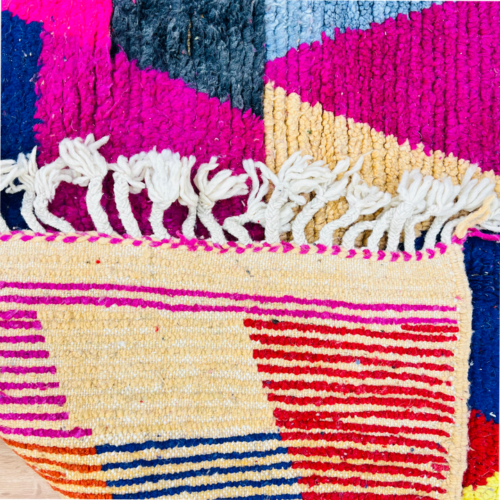 Vintage colorful Moroccan rug with geometric patterns in pink, yellow, and blue. 255 x 150 cm, wool, Berber symbolism.