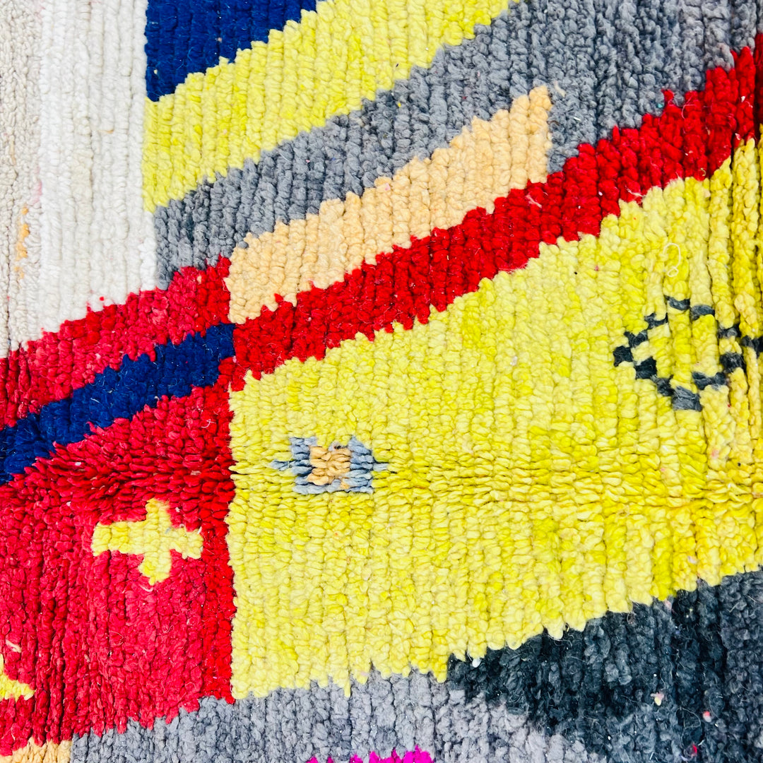 Colorful vintage Moroccan rug with geometric patterns in yellow, red, and navy, handwoven wool, 255 x 150 cm, Berber design.