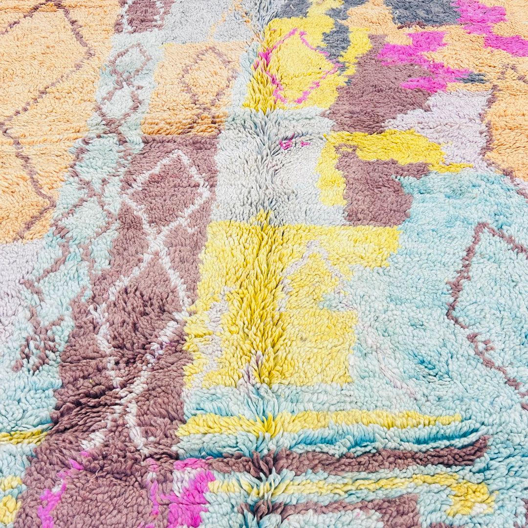 Vintage pastel Moroccan rug with diamond motifs and vibrant colors including honey mustard, mint, and pink. 100% wool, soft texture.
