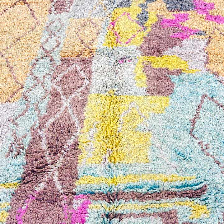 Vintage pastel Moroccan rug with diamond motifs and vibrant colors including honey mustard, mint, and pink. 100% wool, soft texture.