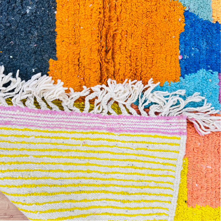 Vintage Moroccan color block wool rug with vibrant design in yellow, black, pink, blue, orange, and green. Handmade Berber craftsmanship.