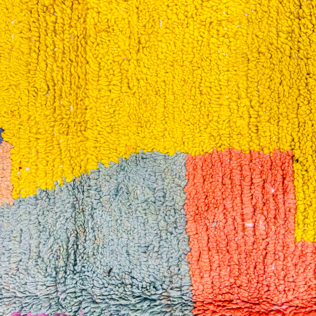 Vintage Moroccan wool rug with vibrant color block design in yellow, orange, and blue, handcrafted by Berber artisans.