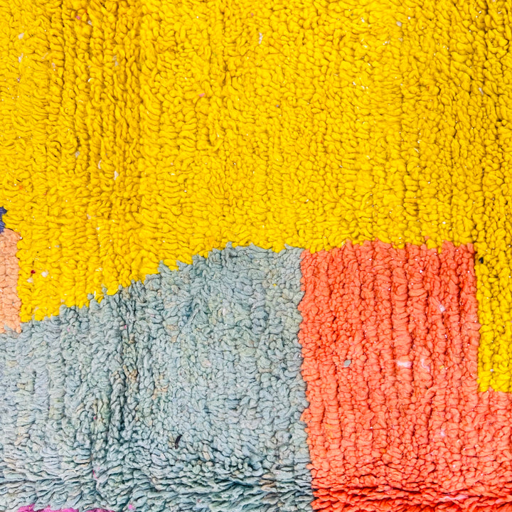 Vintage Moroccan wool rug with vibrant color block design in yellow, orange, and blue, handcrafted by Berber artisans.