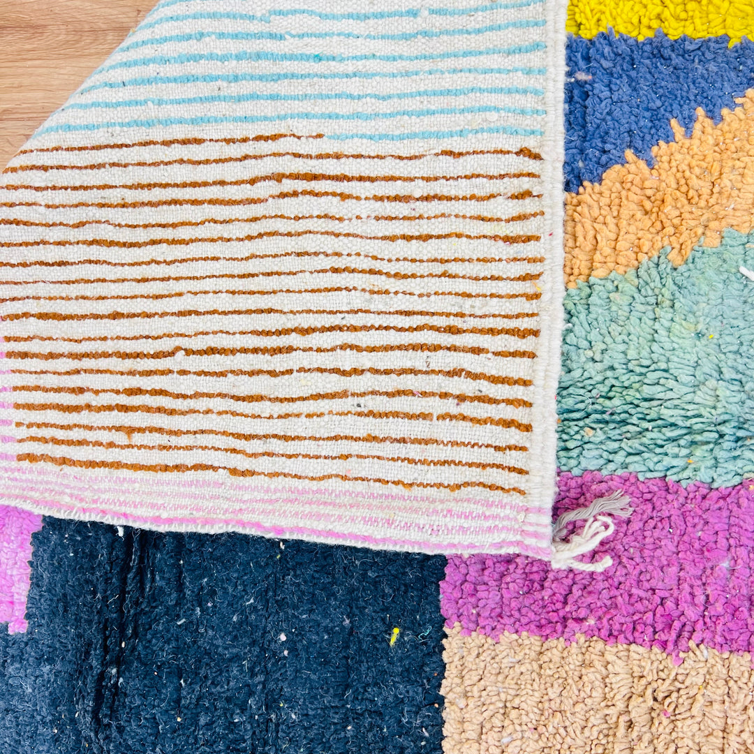 Vintage Moroccan wool rug with colorful abstract design, handcrafted by Berber artisans. Features vibrant stripes and blocks.