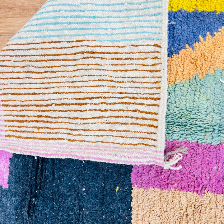 Vintage Moroccan wool rug with colorful abstract design, handcrafted by Berber artisans. Features vibrant stripes and blocks.