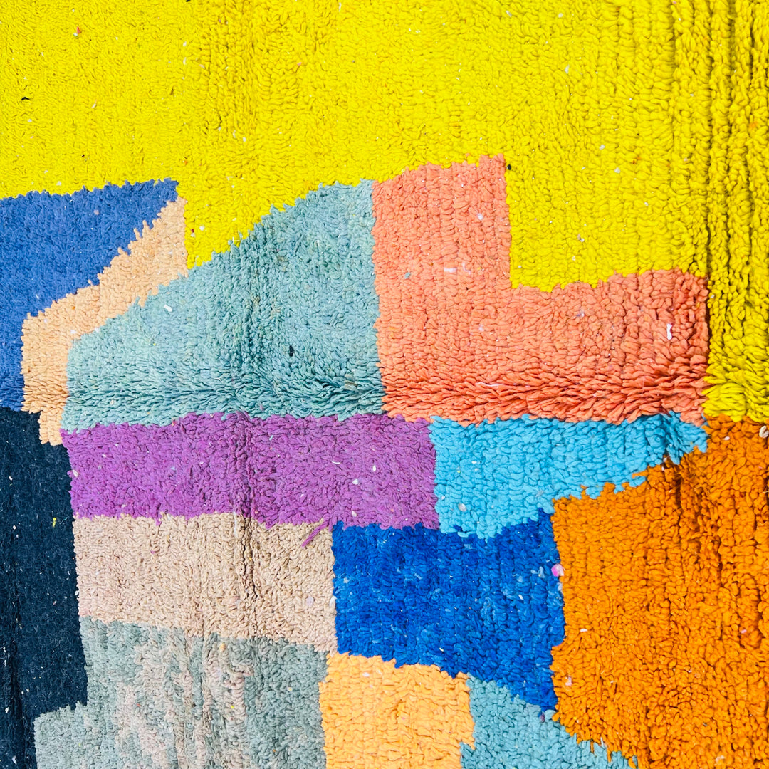 Vintage Moroccan wool rug with abstract color block design in yellow, black, pink, blue, orange, green, and beige.