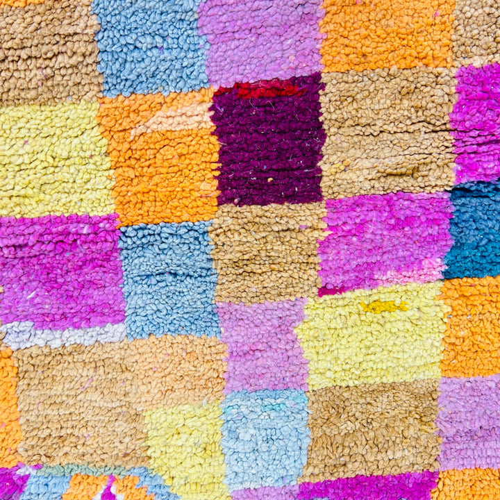 Vintage multicolor Moroccan Berber rug with checkered blocks in yellow, magenta, navy, and pastel. Handwoven wool, size 8.2 x 5.6 ft.