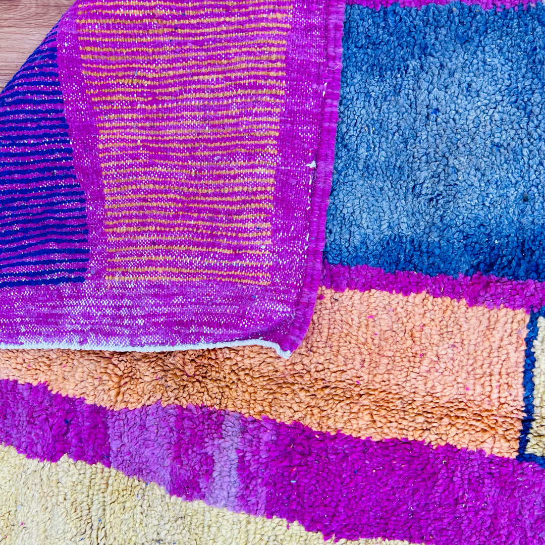 Vintage Moroccan rug with multicolor stripes and checkered blocks, featuring navy, magenta, orange, and pastel hues. Size: 251 x 170 cm.