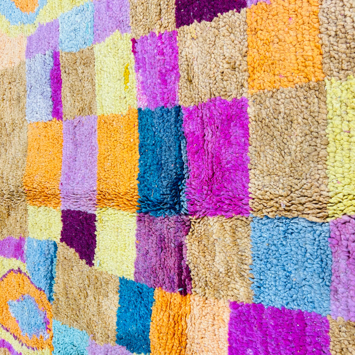 Vintage Moroccan rug with multicolor checkered pattern in yellow, magenta, navy, and pastels. Handwoven Berber design, 100% wool.