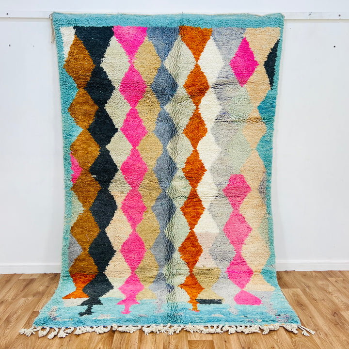 Vintage Moroccan wool rug with bold diamond pattern in pink, terracotta, charcoal, beige, turquoise; hand-knotted, 254x164 cm.