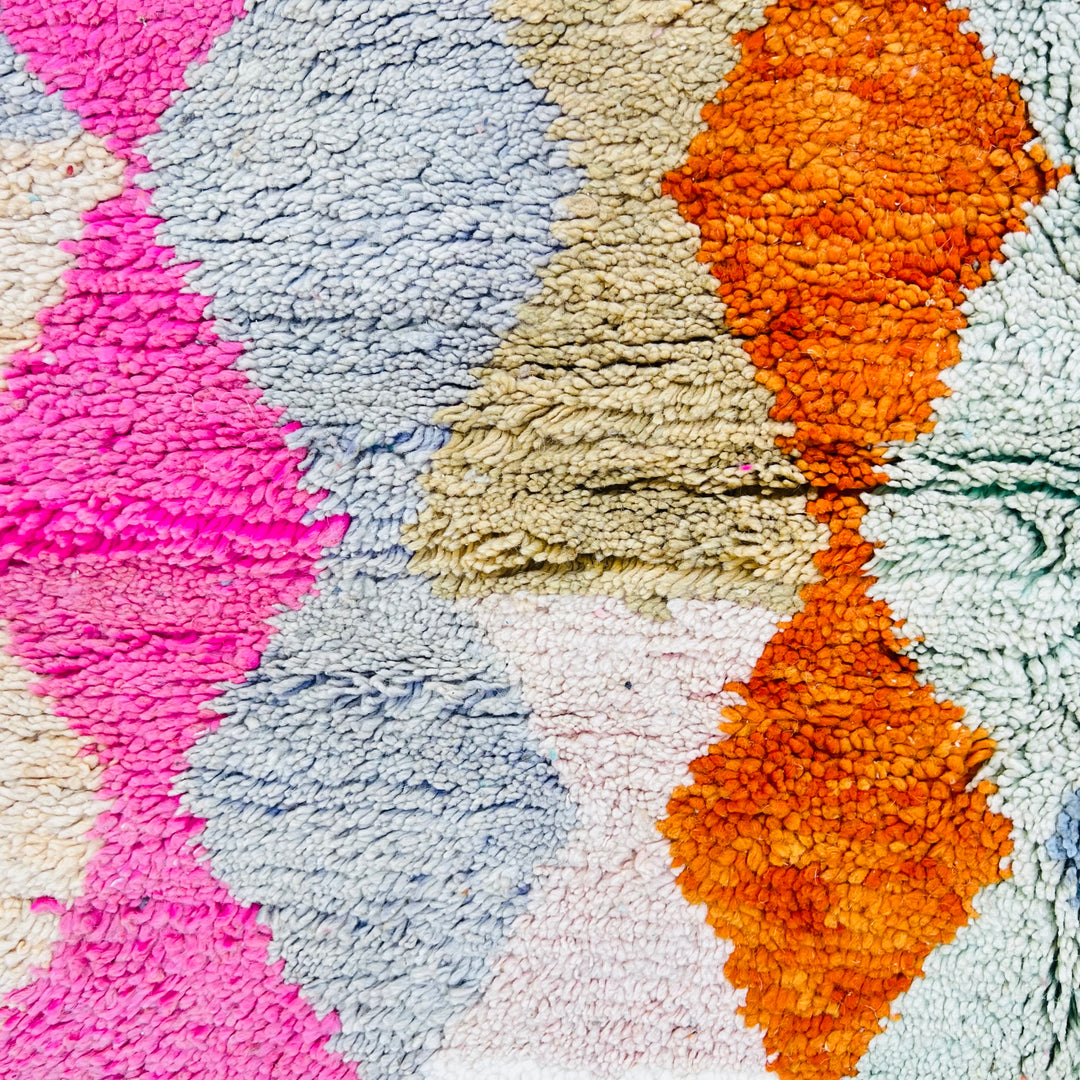 Vintage Moroccan wool rug with bold diamond pattern in pink, terracotta, charcoal, and turquoise hues. Area rug Moroccan style.